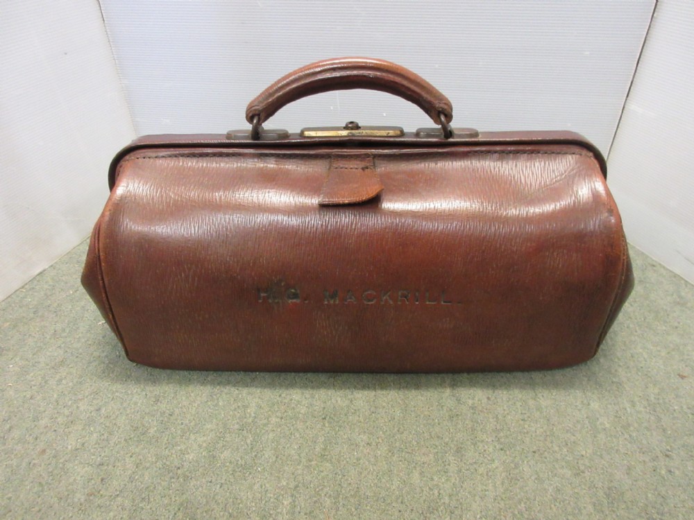 A 1920's small Woody Brown leather gladstone bag purchased from the Army  and Navy Store, monogrammed